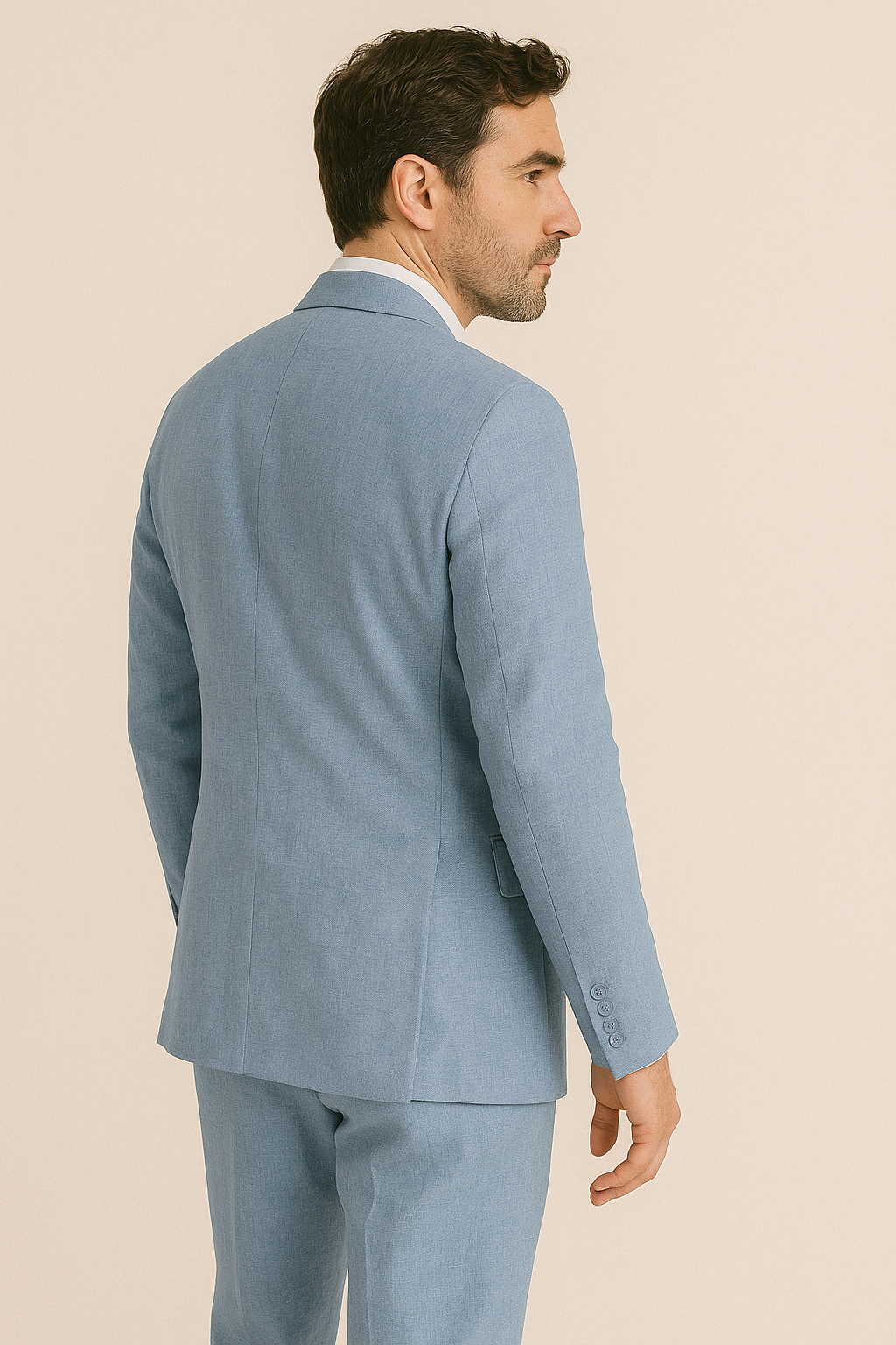 Man wearing a light blue suit on a beige background
