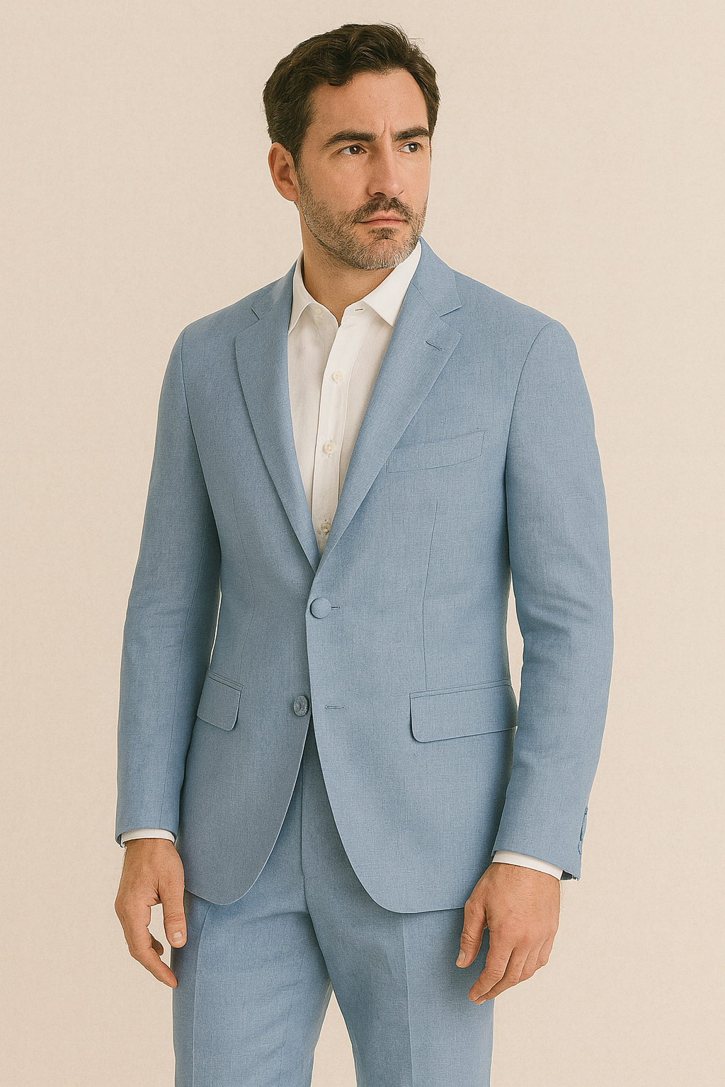 Man wearing a light blue suit with a white shirt on a beige background